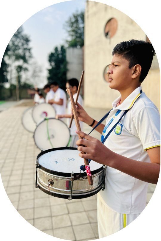 A student playing the snare drum in the school band