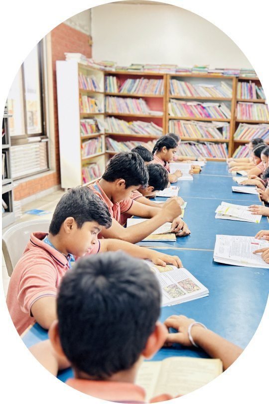 Students reading at long tables in the school library