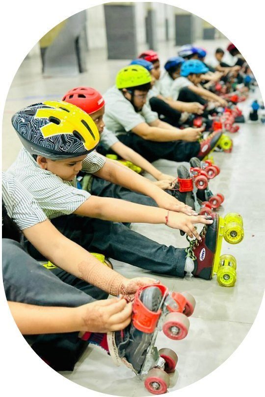 Students in helmets lacing up roller skates