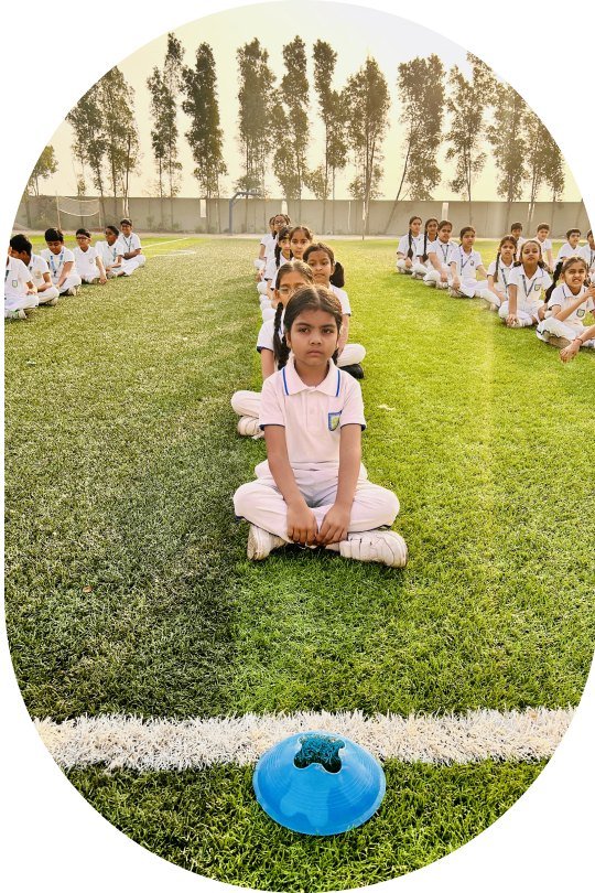 Pupils seated on the lawn during an outdoor session